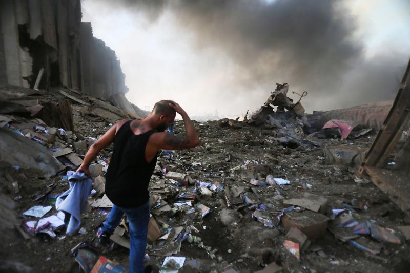 A man walks through debris near the scene of the enormous explosion in Lebanon on Tuesday. At least 70 people were killed, and at least 2,700 people were hurt. The blast shattered windows and damaged buildings across a wide swath of Beirut. A man walks through debris near the scene of the enormous explosion in Lebanon on Tuesday. At least 70 people were killed, and at least 2,700 people were hurt. The blast shattered windows and damaged buildings across a wide swath of Beirut.