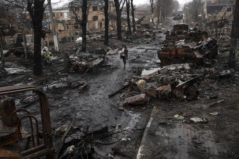 April 3: A woman walks amid destroyed Russian tanks in Bucha, on the outskirts of Kyiv. April 3: A woman walks amid destroyed Russian tanks in Bucha, on the outskirts of Kyiv.