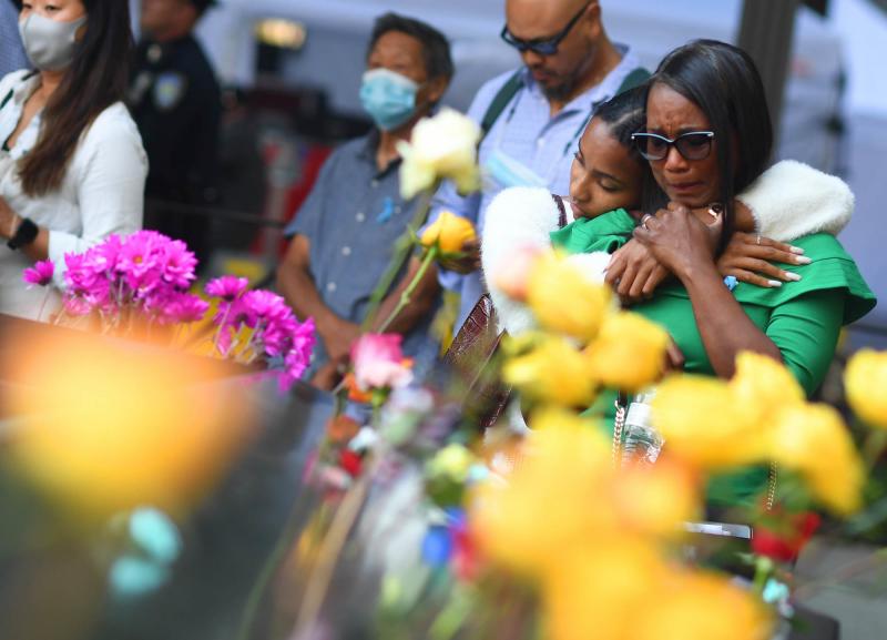 Danielle Booker hugs her mother, Sharon Booker, as the two remember Sean Booker, Danielle's father and Sharon's husband, at the National September 11 Memorial & Museum during a ceremony on Saturday in Manhattan. Sean Booker was a technician on the 93rd fl Danielle Booker hugs her mother, Sharon Booker, as the two remember Sean Booker, Danielle's father and Sharon's husband, at the National September 11 Memorial & Museum during a ceremony on Saturday in Manhattan. Sean Booker was a technician on the 93rd fl