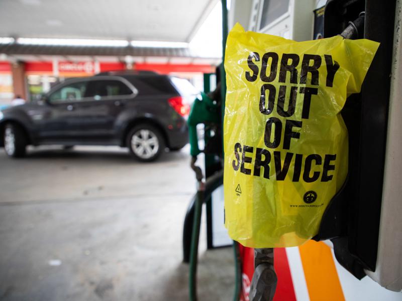 A gas pump is marked "out of service" as cars line up May 11 at a Circle K in Charlotte, N.C., following a ransomware attack that shut down Colonial Pipeline. A gas pump is marked "out of service" as cars line up May 11 at a Circle K in Charlotte, N.C., following a ransomware attack that shut down Colonial Pipeline.