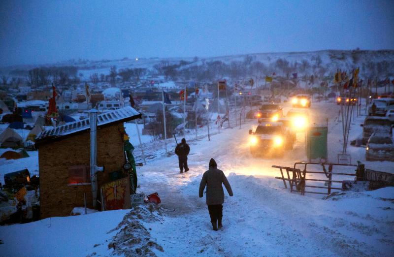 A motorist checks the condition of an exit ramp before attempting to drive out of the Oceti Sakowin camp tonight. A motorist checks the condition of an exit ramp before attempting to drive out of the Oceti Sakowin camp tonight.