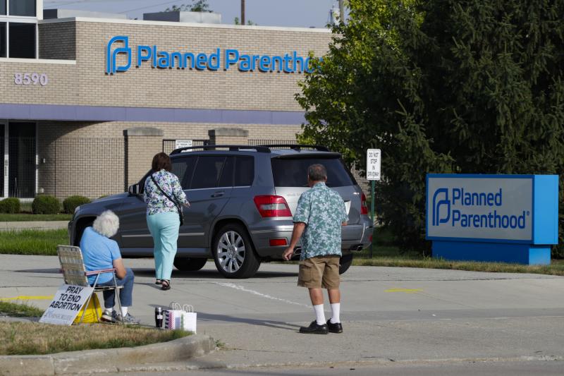 Abortion protesters attempt to hand out literature as they stand in the driveway of a Planned Parenthood clinic in Indianapolis on Aug. 16. Abortion protesters attempt to hand out literature as they stand in the driveway of a Planned Parenthood clinic in Indianapolis on Aug. 16.