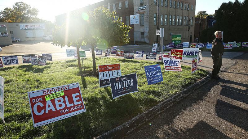 Campaign signs are placed outside a polling precinct open for early voting in Akron, Ohio. Campaign signs are placed outside a polling precinct open for early voting in Akron, Ohio.