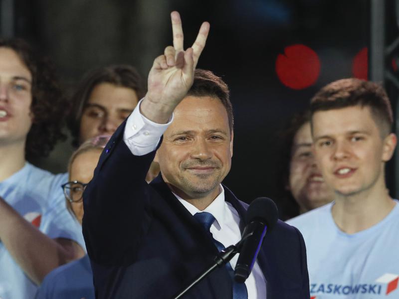 Presidential candidate and Warsaw Mayor Rafal Trzaskowski flashes a victory sign at the end of election day in Warsaw. Presidential candidate and Warsaw Mayor Rafal Trzaskowski flashes a victory sign at the end of election day in Warsaw.