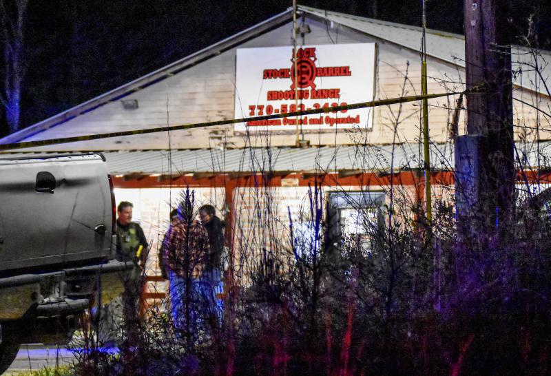 Law enforcement agents investigate the scene of a fatal robbery at Lock Stock & Barrel Shooting Range late Friday, April 8, 2022 in Coweta County, Ga., about 50 miles southwest of Atlanta. Law enforcement agents investigate the scene of a fatal robbery at Lock Stock & Barrel Shooting Range late Friday, April 8, 2022 in Coweta County, Ga., about 50 miles southwest of Atlanta.