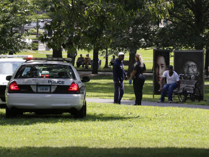 A police officer speaks to a man walking on New Haven Green, Wednesday, Aug. 15, in New Haven, Conn. More than a 100 people fell ill from suspected drug overdoses linked to a batch of synthetic marijuana laced with fubinaca. A police officer speaks to a man walking on New Haven Green, Wednesday, Aug. 15, in New Haven, Conn. More than a 100 people fell ill from suspected drug overdoses linked to a batch of synthetic marijuana laced with fubinaca.