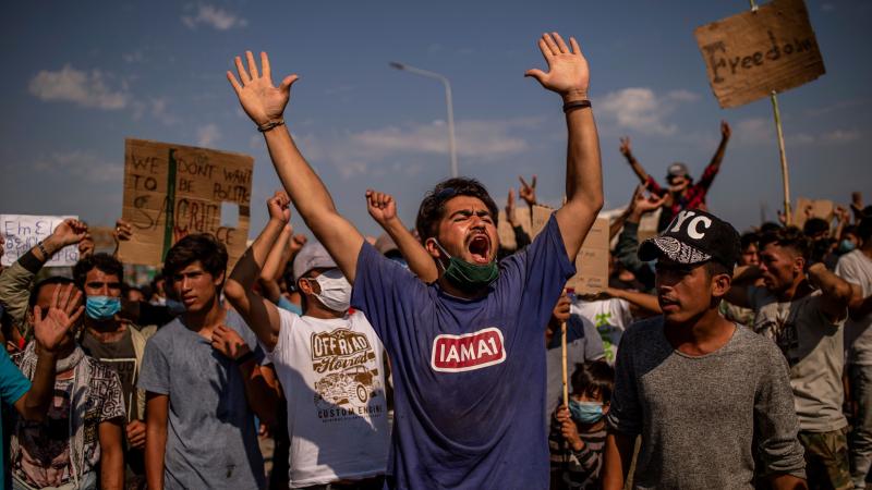 Refugees from the Moria camp protest near Mytilene on the Greek island of Lesbos on Saturday, a few days after a fire destroyed the refugee camp. Refugees from the Moria camp protest near Mytilene on the Greek island of Lesbos on Saturday, a few days after a fire destroyed the refugee camp.