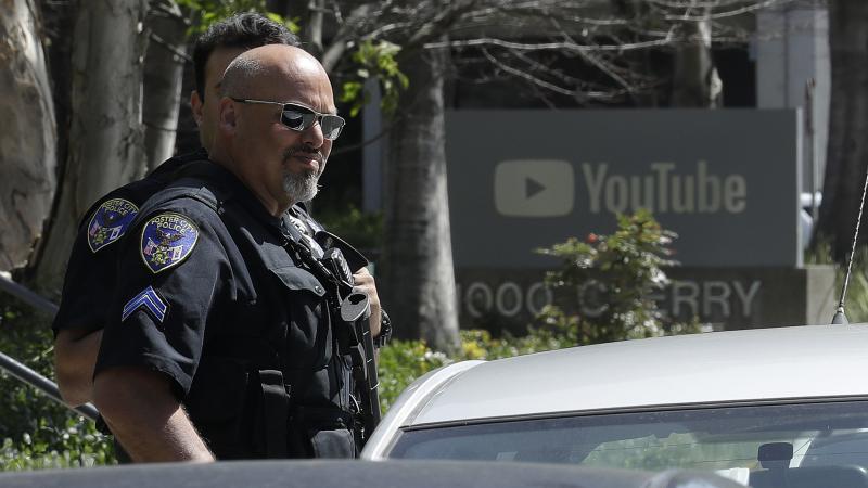 Police officers keep watch outside YouTube's headquarters Tuesday in San Bruno, Calif., after a woman opened fire on workers there. The shooter had vented her frustration with YouTube's recent decision on advertising revenue. Police officers keep watch outside YouTube's headquarters Tuesday in San Bruno, Calif., after a woman opened fire on workers there. The shooter had vented her frustration with YouTube's recent decision on advertising revenue.