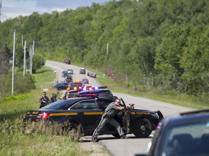 Law enforcement personnel take cover Friday afternoon after cornering two escaped prisoners off of Route 30 in Malone, N.Y. One prisoner, Richard Matt, was shot dead by law enforcement. Authorities were still searching for escapee David Sweat late Friday Law enforcement personnel take cover Friday afternoon after cornering two escaped prisoners off of Route 30 in Malone, N.Y. One prisoner, Richard Matt, was shot dead by law enforcement. Authorities were still searching for escapee David Sweat late Friday