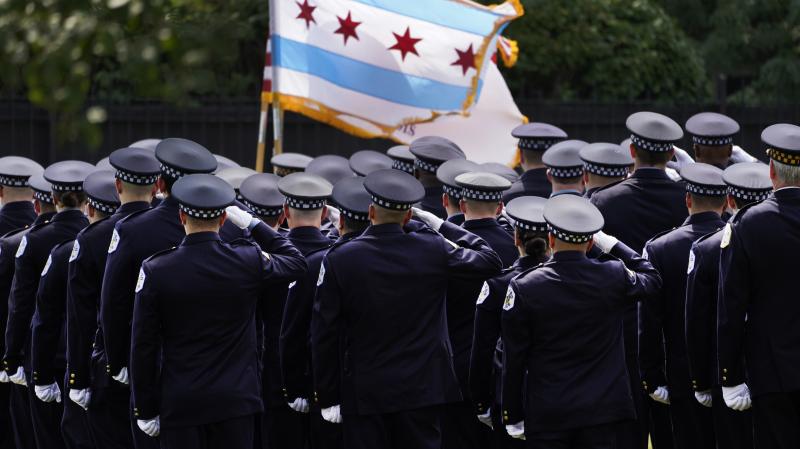 Chicago police officers salute the state flag on Aug. 18. Chicago police officers salute the state flag on Aug. 18.