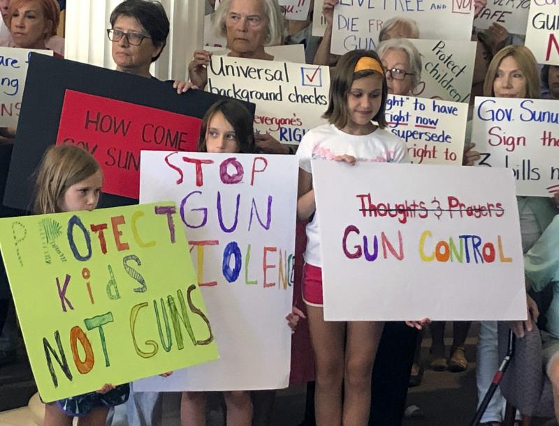 Supporters of gun control measures gather at the Legislative Office Building in Concord, N.H., in August, to urge Republican Gov. Chris Sununu to act after mass shootings in Texas and Ohio. Supporters of gun control measures gather at the Legislative Office Building in Concord, N.H., in August, to urge Republican Gov. Chris Sununu to act after mass shootings in Texas and Ohio.