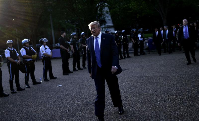 President Trump walks back to the White House escorted by the Secret Service after appearing outside of St John's Episcopal church across Lafayette Park in Washington, D.C., on Monday. President Trump walks back to the White House escorted by the Secret Service after appearing outside of St John's Episcopal church across Lafayette Park in Washington, D.C., on Monday.