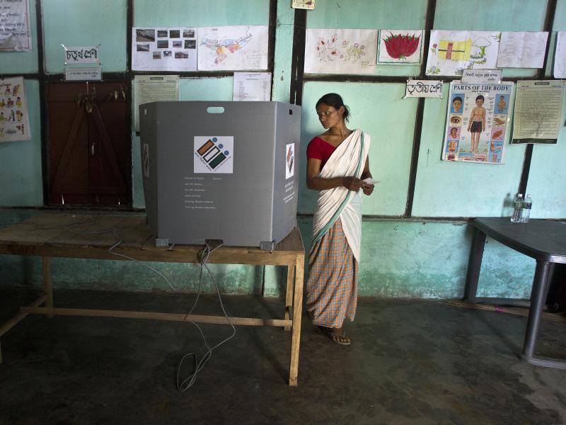 An Indian Mishing tribal woman looks back to ensure her vote has been cast as she prepares to leave the voting compartment during the first phase of general elections in Majuli, Assam, India, Thursday. An Indian Mishing tribal woman looks back to ensure her vote has been cast as she prepares to leave the voting compartment during the first phase of general elections in Majuli, Assam, India, Thursday.