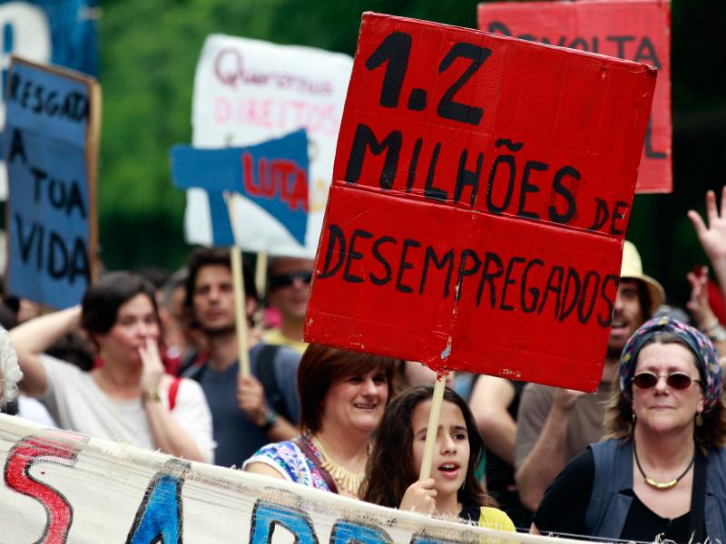 A young girl holds a sign with the words "1.2 Million Unemployed" during an anti-austerity protest in Lisbon on May 12, 2012. A young girl holds a sign with the words "1.2 Million Unemployed" during an anti-austerity protest in Lisbon on May 12, 2012.