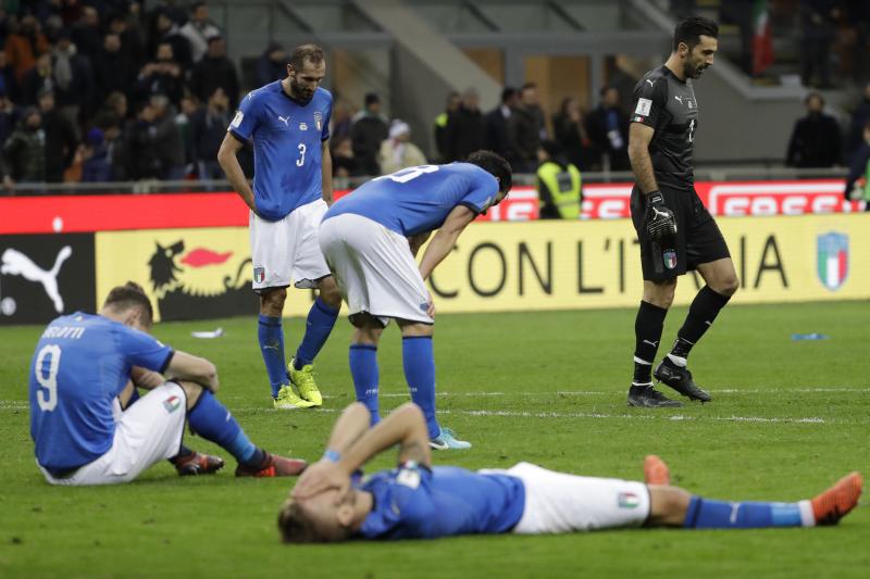 Italian national team players slump in dejection at the end of their World Cup qualifying match against Sweden on Monday. The 0-0 draw killed the four-time world champions' hopes of a spot in the 2018 tournament. Italian national team players slump in dejection at the end of their World Cup qualifying match against Sweden on Monday. The 0-0 draw killed the four-time world champions' hopes of a spot in the 2018 tournament.