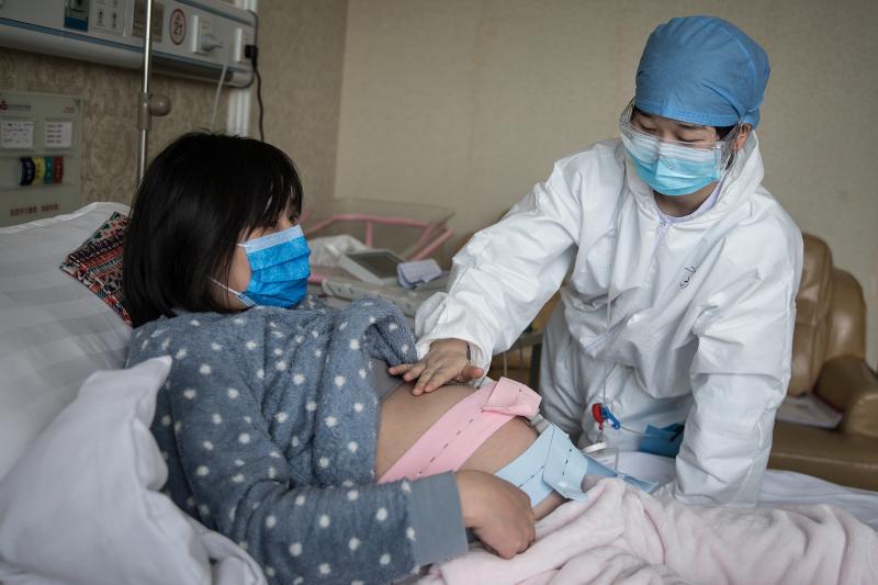 A nurse examines a pregnant woman in a private obstetric hospital in Wuhan, China, in February. Research from China suggests pregnancy does make women more vulnerable to the coronavirus. A nurse examines a pregnant woman in a private obstetric hospital in Wuhan, China, in February. Research from China suggests pregnancy does make women more vulnerable to the coronavirus.