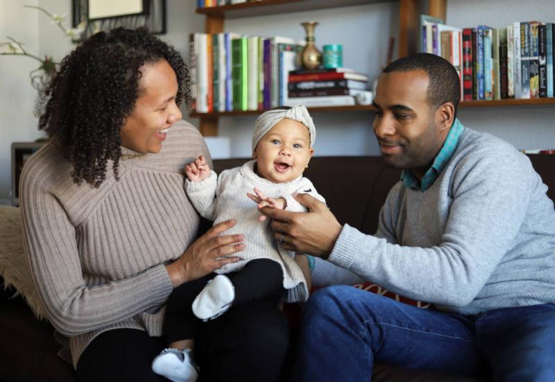 Shara and Robert Watkins hold their 5-month-old daughter, Kaiya, in their home in San Mateo, Calif., just after she had woken up from an afternoon nap. Shara and Robert Watkins hold their 5-month-old daughter, Kaiya, in their home in San Mateo, Calif., just after she had woken up from an afternoon nap.