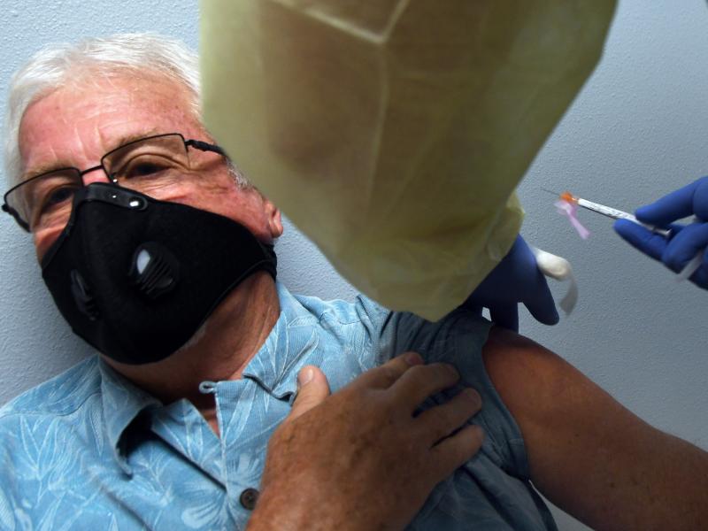 Tony Potts, 69, a retiree from Ormond Beach, Fla., receives his first Moderna COVID-19 vaccine shot Tuesday as part of the company's phase three clinical trial. Tony Potts, 69, a retiree from Ormond Beach, Fla., receives his first Moderna COVID-19 vaccine shot Tuesday as part of the company's phase three clinical trial.