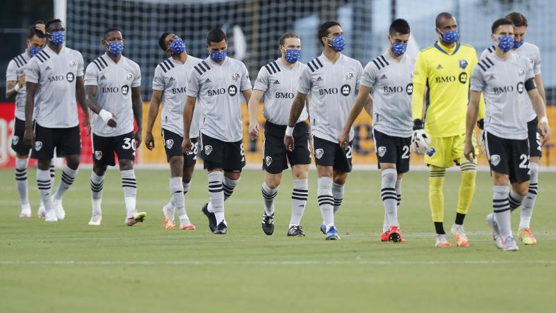 Members of the Montreal Impact, wearing masks, take the field for their match against Toronto FC as part of the MLS Is Back Tournament Thursday in Reunion, Fla. Members of the Montreal Impact, wearing masks, take the field for their match against Toronto FC as part of the MLS Is Back Tournament Thursday in Reunion, Fla.