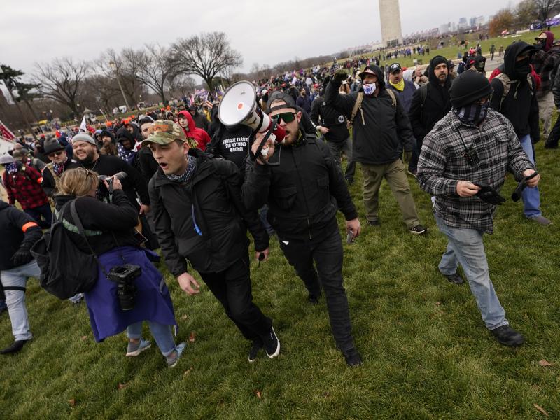 Ethan Nordean, with backward baseball hat and bullhorn, leads members of the far-right group Proud Boys before the riot at the U.S. Capitol on Jan. 6. The self-described sergeant-at-arms of the Seattle Proud Boys is facing federal charges over his role in Ethan Nordean, with backward baseball hat and bullhorn, leads members of the far-right group Proud Boys before the riot at the U.S. Capitol on Jan. 6. The self-described sergeant-at-arms of the Seattle Proud Boys is facing federal charges over his role in
