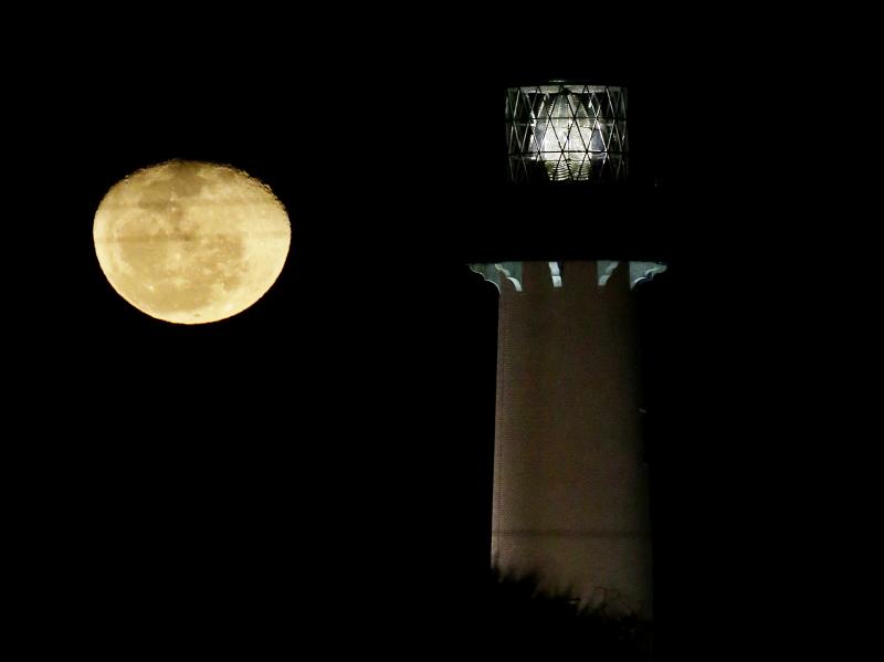 The moon, in its waning gibbous state, rises near the Jupiter Lighthouse in 2013, in Jupiter, Fla. The 108-feet tall, brick structure was first lit in 1860. The lighthouse sits atop a Native American archaeological site, which is at risk from the rising s The moon, in its waning gibbous state, rises near the Jupiter Lighthouse in 2013, in Jupiter, Fla. The 108-feet tall, brick structure was first lit in 1860. The lighthouse sits atop a Native American archaeological site, which is at risk from the rising s