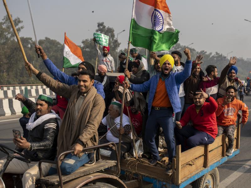 Protesting farmers riding tractors shout slogans as they march to the capital during India's Republic Day celebrations on Tuesday in New Delhi. Protesting farmers riding tractors shout slogans as they march to the capital during India's Republic Day celebrations on Tuesday in New Delhi.