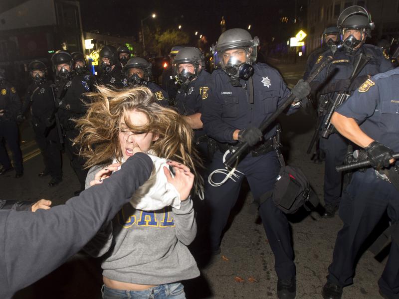 A protester flees as police officers try to disperse a crowd comprised largely of student demonstrators during a protest against police violence in the U.S., in Berkeley, California early Sunday. A protester flees as police officers try to disperse a crowd comprised largely of student demonstrators during a protest against police violence in the U.S., in Berkeley, California early Sunday.