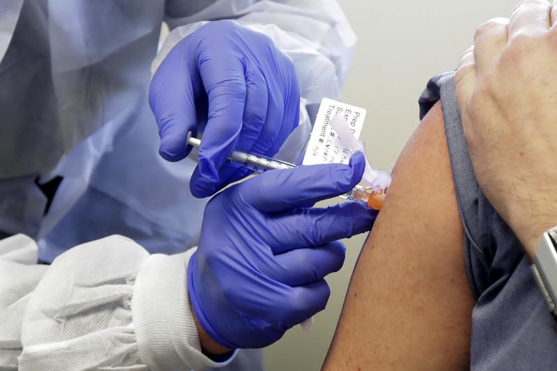 A patient in a first-stage study of a potential vaccine for COVID-19 receives a shot in March at the Kaiser Permanente Washington Health Research Institute in Seattle. A patient in a first-stage study of a potential vaccine for COVID-19 receives a shot in March at the Kaiser Permanente Washington Health Research Institute in Seattle.