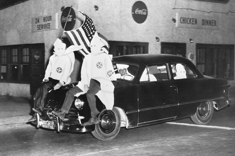 In 1949, Ku Klux Klan members ride down a street in Gadsden, Ala., as part of an 18-car parade. In 1949, Ku Klux Klan members ride down a street in Gadsden, Ala., as part of an 18-car parade.