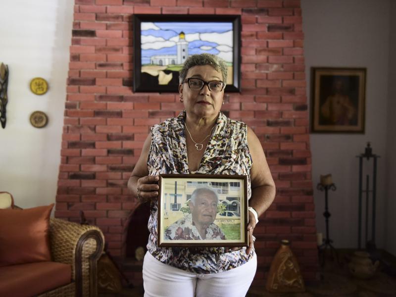 Puerto Rican Nerybelle Perez poses with a portrait of her father, World War II veteran Efrain Perez, who died after his ambulance was turned away from the island's largest public hospital when it had no electricity or water following Hurricane Maria. Puerto Rican Nerybelle Perez poses with a portrait of her father, World War II veteran Efrain Perez, who died after his ambulance was turned away from the island's largest public hospital when it had no electricity or water following Hurricane Maria.