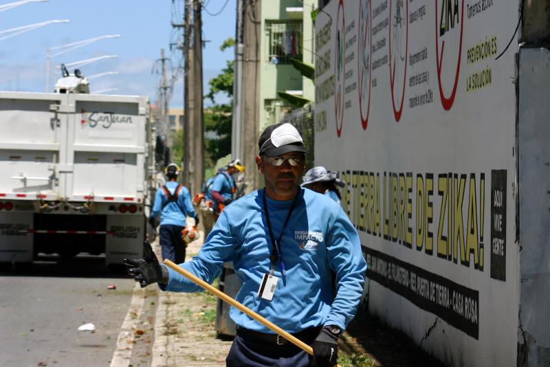 A city worker in San Juan, Puerto Rico, cleans up a vacant lot where mosquitoes could be breeding. A city worker in San Juan, Puerto Rico, cleans up a vacant lot where mosquitoes could be breeding.