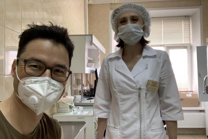This week NPR Moscow correspondent Lucian Kim got vaccinated with Sputnik V, the COVID-19 vaccine that Russian President Vladimir Putin is promoting as the best in the world. Above: Kim smiles (behind his mask) after his shot. This week NPR Moscow correspondent Lucian Kim got vaccinated with Sputnik V, the COVID-19 vaccine that Russian President Vladimir Putin is promoting as the best in the world. Above: Kim smiles (behind his mask) after his shot.