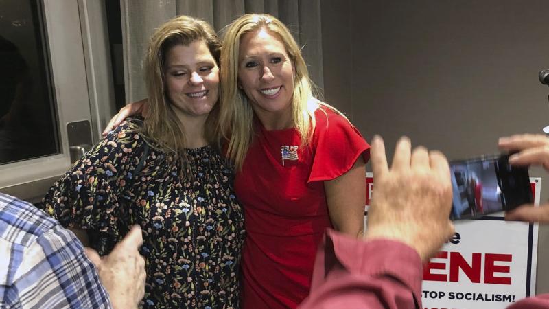 Marjorie Taylor Greene (right) poses with a supporter in Rome, Ga., late Tuesday. Greene, criticized for promoting bigoted videos and supporting the far-right QAnon conspiracy theory, won the GOP nomination for Georgia's 14th Congressional District. Marjorie Taylor Greene (right) poses with a supporter in Rome, Ga., late Tuesday. Greene, criticized for promoting bigoted videos and supporting the far-right QAnon conspiracy theory, won the GOP nomination for Georgia's 14th Congressional District.