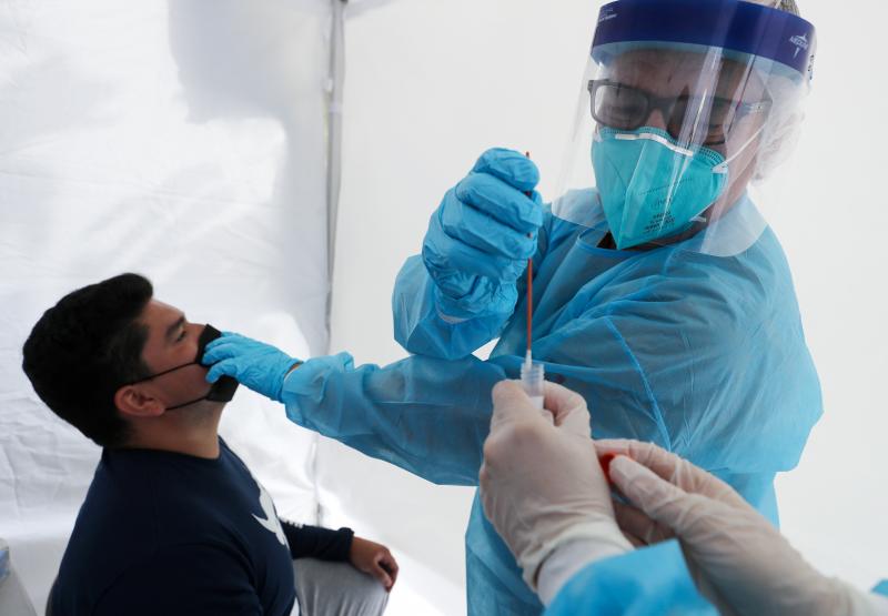 Dr. Glenn Lopez administered a standard test for the coronavirus to Daniel Contreras at a mobile clinic in South Los Angeles last week. Though highly accurate, such tests can take days or more to process. Dr. Glenn Lopez administered a standard test for the coronavirus to Daniel Contreras at a mobile clinic in South Los Angeles last week. Though highly accurate, such tests can take days or more to process.