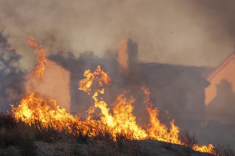 Flames approach houses during the Tick Fire on Oct. 24, 2019 in Canyon Country, California. Flames approach houses during the Tick Fire on Oct. 24, 2019 in Canyon Country, California.