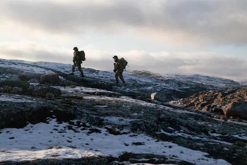 Two privates walk on the mountain just outside the border post. Two privates walk on the mountain just outside the border post.