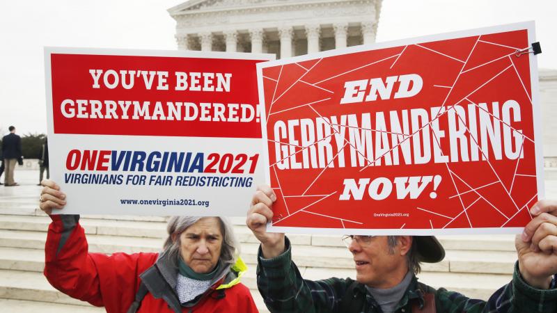 Sara Fitzgerald and Michael Martin, both with the group One Virginia, protest gerrymandering in front of the Supreme Court in March 2018. Sara Fitzgerald and Michael Martin, both with the group One Virginia, protest gerrymandering in front of the Supreme Court in March 2018.