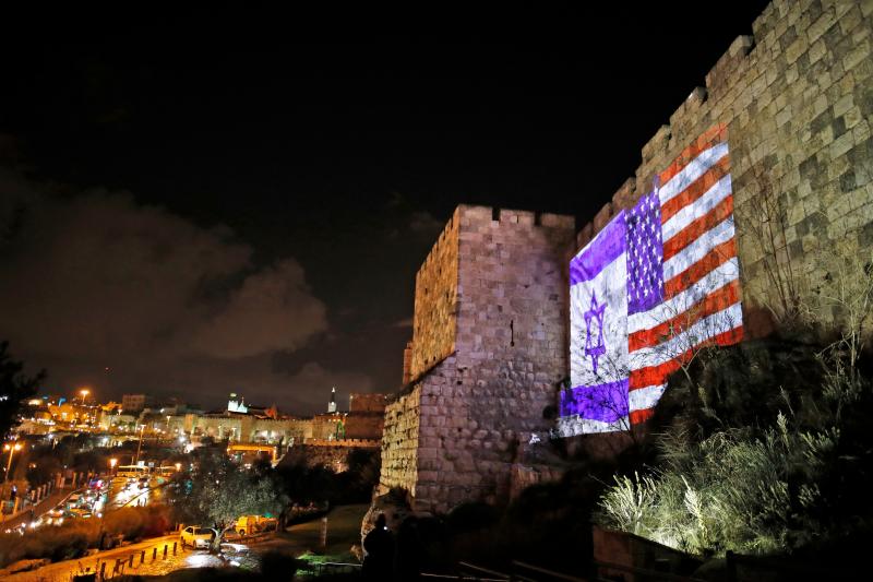 The American and Israeli flags are on display Wednesday on the walls of the Old City of Jerusalem. President Trump announced that the U.S. will view Jerusalem as the capital of Israel, and he ordered the State Department to "begin preparation to move the The American and Israeli flags are on display Wednesday on the walls of the Old City of Jerusalem. President Trump announced that the U.S. will view Jerusalem as the capital of Israel, and he ordered the State Department to "begin preparation to move the