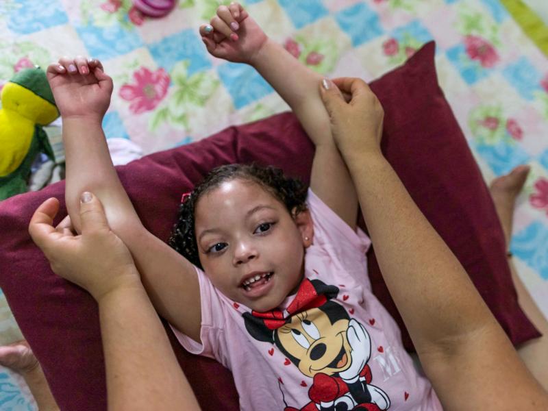 Rochelle dos Santos helps her daughter with physical therapy. Many children with congenital Zika disorder are physically disabled. Rochelle dos Santos helps her daughter with physical therapy. Many children with congenital Zika disorder are physically disabled.