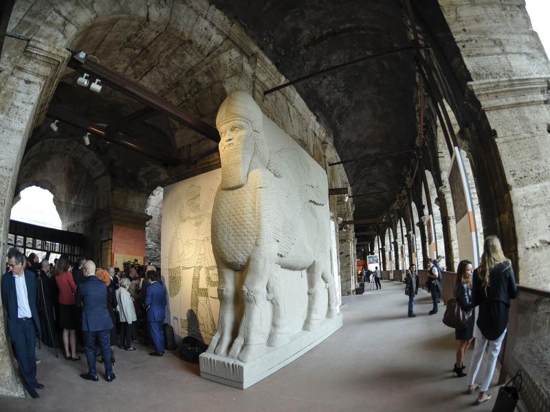People walk past a replica of an ancient statue of a human-headed winged bull from Nimrud, Iraq, destroyed by the Islamic State. It's part of an exhibition called "Rising from Destruction" at Rome's Colosseum. People walk past a replica of an ancient statue of a human-headed winged bull from Nimrud, Iraq, destroyed by the Islamic State. It's part of an exhibition called "Rising from Destruction" at Rome's Colosseum.