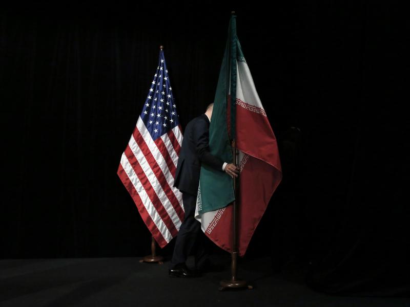 A staff person removes the Iranian flag from the stage after a group picture with representatives of the United States, Iran, China, Russia, Britain, Germany, France and the European Union during the Iran nuclear talks in July 2015 in Vienna. A staff person removes the Iranian flag from the stage after a group picture with representatives of the United States, Iran, China, Russia, Britain, Germany, France and the European Union during the Iran nuclear talks in July 2015 in Vienna.