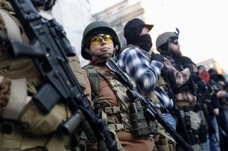 Demonstrators stand outside a security zone in Richmond, Va., on Monday. Thousands of activists and gun enthusiasts converged on the city to urge the state not to pass new gun laws. Demonstrators stand outside a security zone in Richmond, Va., on Monday. Thousands of activists and gun enthusiasts converged on the city to urge the state not to pass new gun laws.