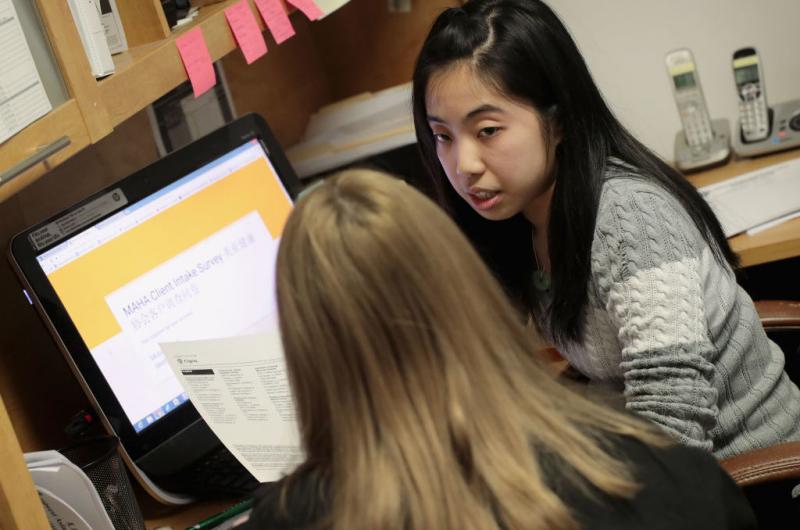 Kelley Mui helps a client sign up for health insurance through the Affordable Care Act on Dec. 15 at the Midwest Asian Health Association in Chicago. Kelley Mui helps a client sign up for health insurance through the Affordable Care Act on Dec. 15 at the Midwest Asian Health Association in Chicago.