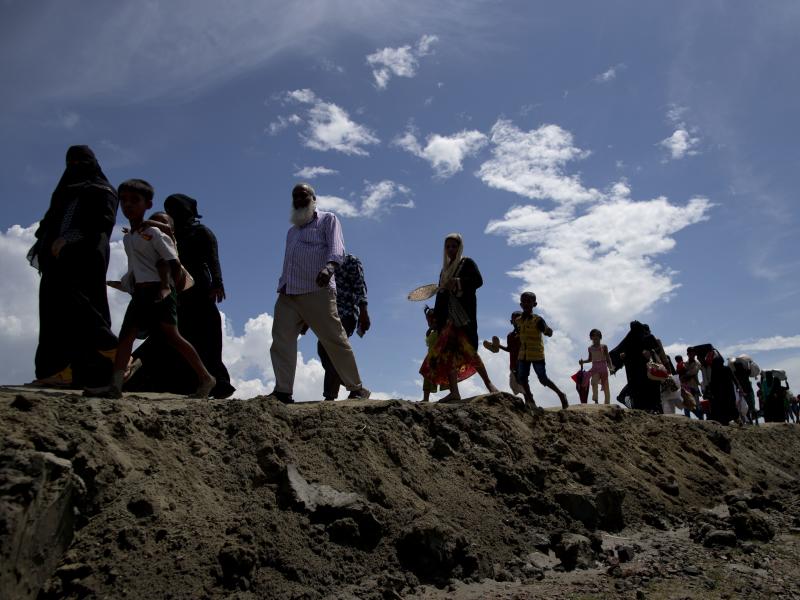 Newly arrived Rohingya Muslims from Myanmar walk to a camp for refugees in Teknaf, Bangladesh, on Monday. Hundreds of thousands of Rohingya refugees have streamed across the border following Myanmarese military retaliation for attacks by a Rohingya milita Newly arrived Rohingya Muslims from Myanmar walk to a camp for refugees in Teknaf, Bangladesh, on Monday. Hundreds of thousands of Rohingya refugees have streamed across the border following Myanmarese military retaliation for attacks by a Rohingya milita