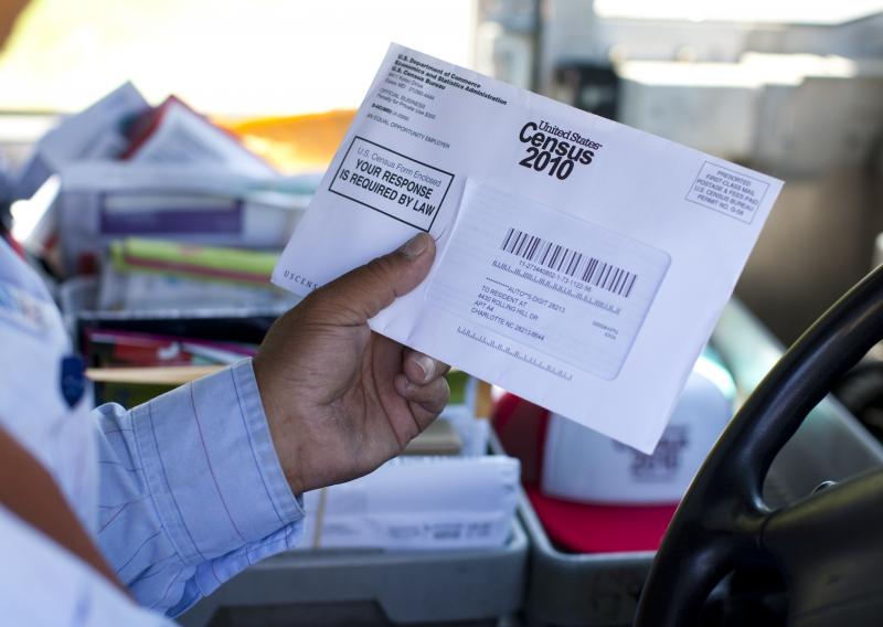 U.S. Postal Service mail carrier Thomas Russell holds a census form while working his route in 2010. U.S. Postal Service mail carrier Thomas Russell holds a census form while working his route in 2010.