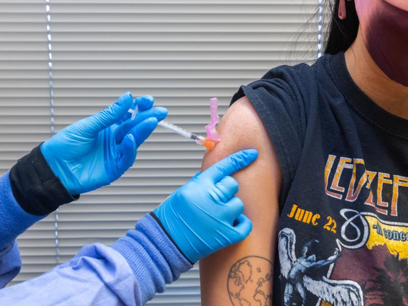 A health care worker administers a COVID-19 vaccine to a resident at the Jordan Valley Community Health Center in Springfield, Mo., in June. A health care worker administers a COVID-19 vaccine to a resident at the Jordan Valley Community Health Center in Springfield, Mo., in June.