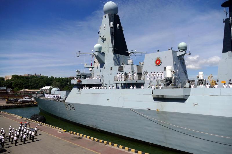 The British Royal Navy destroyer HMS Defender in the port of Odessa, Ukraine, on Tuesday. Russia said it fired warning shots at the warship Wednesday when it entered territorial waters off Crimea. The British Royal Navy destroyer HMS Defender in the port of Odessa, Ukraine, on Tuesday. Russia said it fired warning shots at the warship Wednesday when it entered territorial waters off Crimea.
