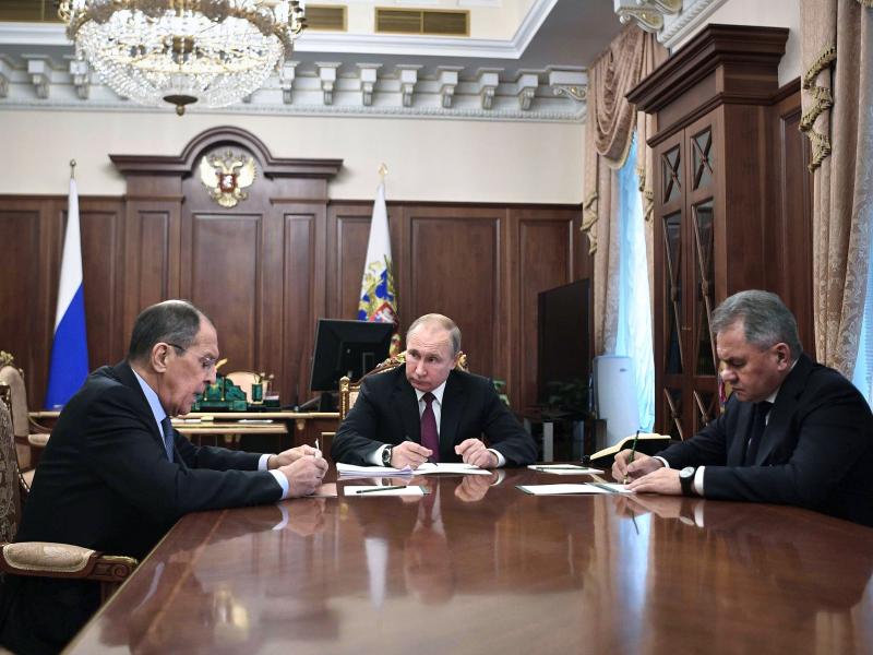 Russian President Vladimir Putin (center) attends a meeting with Russian Foreign Minister Sergey Lavrov (left) and Defense Minister Sergei Shoigu in the Kremlin in Moscow on Saturday. Putin said Russia would abandon the 1987 Intermediate-Range Nuclear For Russian President Vladimir Putin (center) attends a meeting with Russian Foreign Minister Sergey Lavrov (left) and Defense Minister Sergei Shoigu in the Kremlin in Moscow on Saturday. Putin said Russia would abandon the 1987 Intermediate-Range Nuclear For