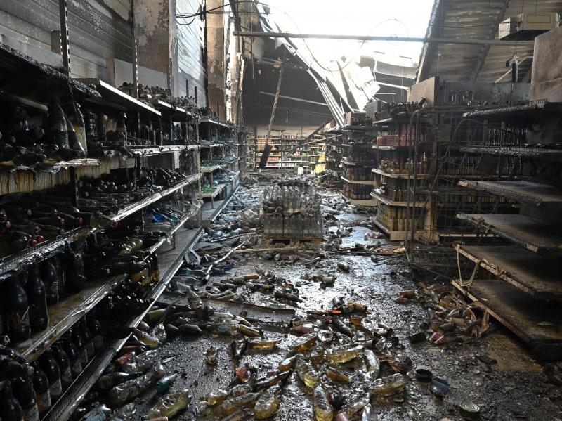 A photograph taken Tuesday shows charred goods in a grocery store of the destroyed Amstor mall in Kremenchuk, central Ukraine, one day after it was hit by a Russian missile strike. A photograph taken Tuesday shows charred goods in a grocery store of the destroyed Amstor mall in Kremenchuk, central Ukraine, one day after it was hit by a Russian missile strike.