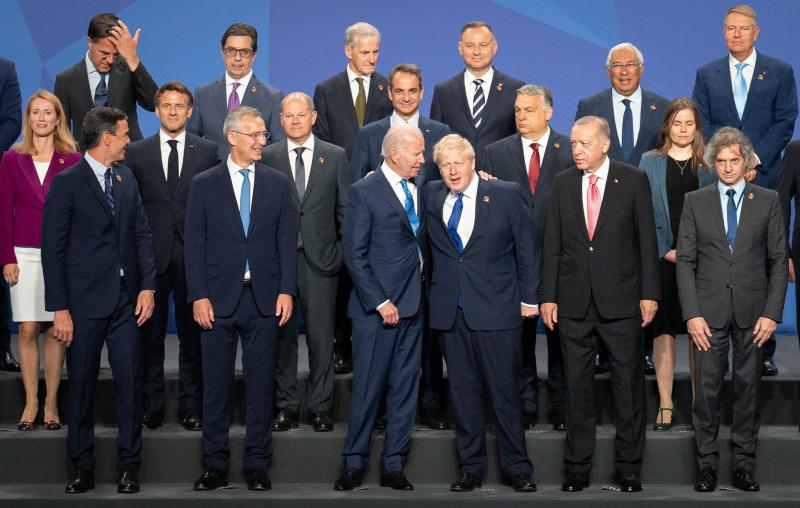 British Prime Minister Boris Johnson stands beside President Biden and other world leaders posing for a photo during the NATO summit on Wednesday in Madrid, Spain. The defense alliance declared Russia a direct threat and members are committing to boost tr British Prime Minister Boris Johnson stands beside President Biden and other world leaders posing for a photo during the NATO summit on Wednesday in Madrid, Spain. The defense alliance declared Russia a direct threat and members are committing to boost tr